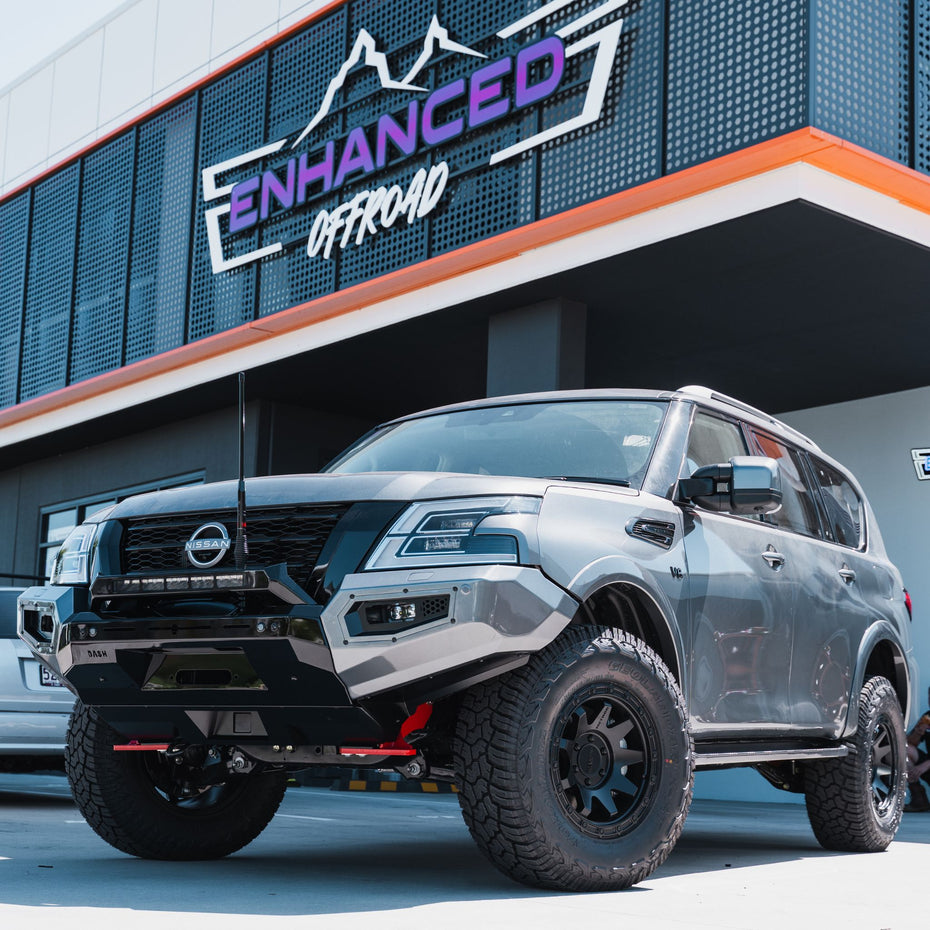 This is an image of a Charcoal Gunmetal Grey Nissan Patrol Y62 2026 model with Dash Offroad Bull Bar, GME XRS Connect UHF radio, MSA Towing Mirrors, Method Race Wheels, and Yokohama Geolander x A/T's